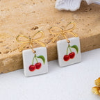 Gold Bow Drop Charm Earrings